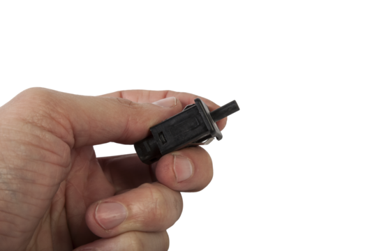 brake light switch in the hand under the brake pedal in a car on a white isolated background. catalog of spare parts for websites and advertising.