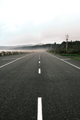Road along the ocean at stormy weather, new zealand