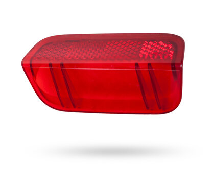 A  transparent plastic red shade for illuminating the interior on a white isolated background in a photo studio - spare parts for repairing a car interior or for sale in a auto service.