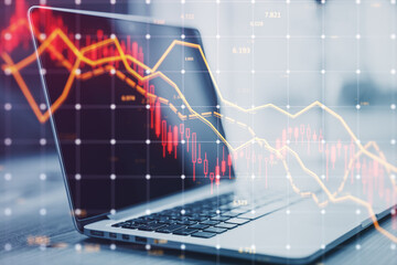 Laptop with stock market downturn graphs