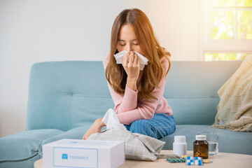 Sick woman. Beautiful female health problem blowing nose use pharmacy kit box delivery service from...