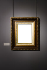 In an art museum, a picture frame with an empty canvas hangs on the wall