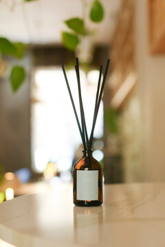 Empty-Label Diffuser Bottle with Wooden Sticks for Home, Featuring Organic Essential Oil - Stylish Black Hue on a Modern Background