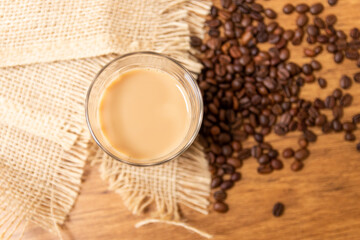 Cup of hot coffee and milk in American glass, traditional breakfast in brazil. background with jute and coffee beans
