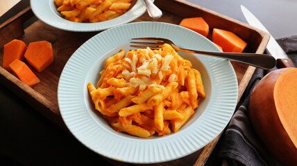Healthy whole grain Penne, tube shaped pasta with pumpkin, goat cheese