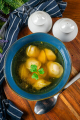 Pelmeni filled with meat served in broth.
