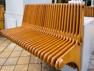 Modern wooden bench assembled from plywood slats