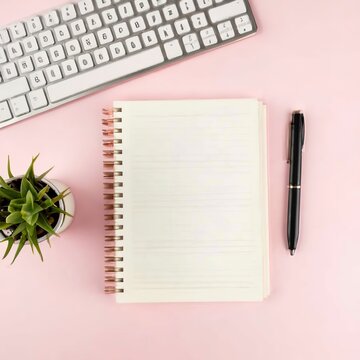 Blank notepad page for text on pink office desktop. Top view of modern bright table with notebook, keyboard