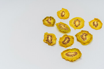 dried kiwi slices on a white background. kiwi dried in a dehydrator for preparing food and drinks....