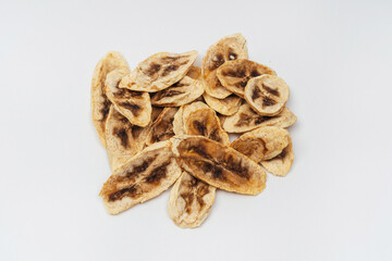 dried banana slices on a white background. banana dried in a dehydrator for preparing food and drinks. banana chips on a light background