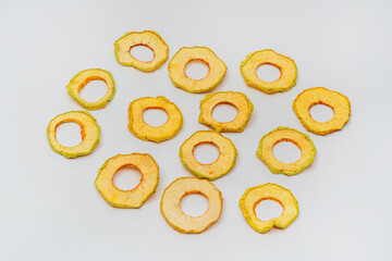 dried apple slices on a white background. apple dried in a dehydrator for preparing food and drinks. apple chips on a light background
