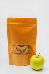 dried apple slices in a pack on a white background. apple dried in a dehydrator for preparing food and drinks. apple chips in a bag on a light background