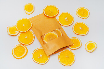 dried orange slices in a pack on a white background. orange dried in a dehydrator for preparing food and drinks. orange chips in a bag on a light background
