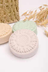 Three pieces of natural household soap on white background