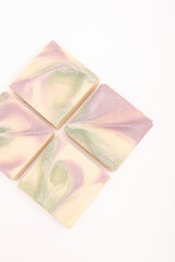 Four pieces of natural soap with an abstract pattern on white background. Handmade soap