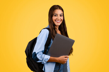 Glad confident european teenager student, pupil lady with backpack with computer