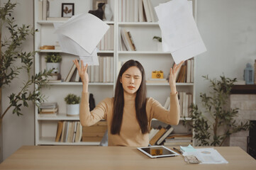 Asian Businesswoman Throwing Papers in Her Office in Angry Mood