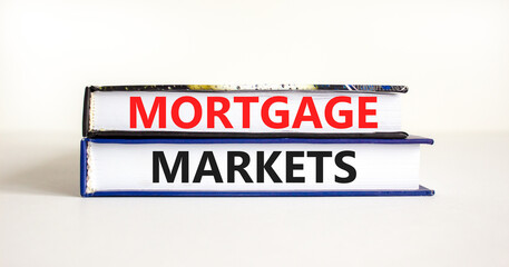 Fototapeta premium Mortgage markets symbol. Concept words Mortgage markets on beautiful books. Beautiful white table white background. Business mortgage markets concept. Copy space.
