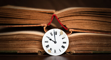 Old book and antique clock face. Storytelling, story teller, time background or banner.