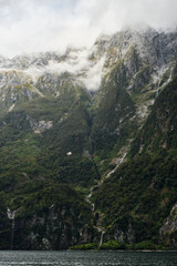 Fototapeta na wymiar waterfall in the fjords of milford sound, new zealand