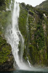waterfall in the fjords of milford sound, new zealand