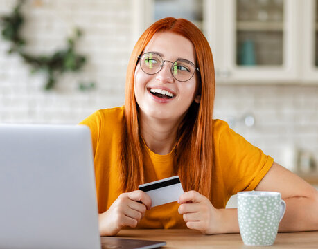 Woman is doing online purchases  using laptop computer sitting at home, shopping concept