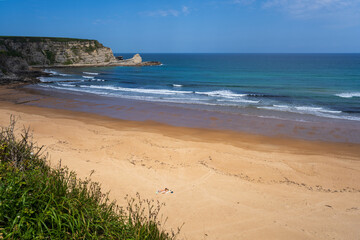 Playa de Langre is a sandy beach, perfect for sunbathing, surrounded by cliffs by the Cantabrian sea, Cantabria, Spain