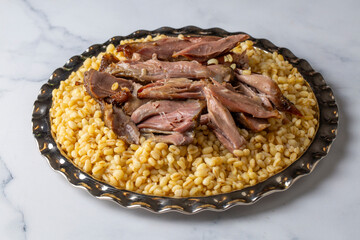 Turkish foods; lamb shank tandoori on bulgur wheat rice (Turkish name; bulgur bugday pilavi kuzu incik tandir)