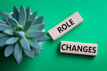 Role changes symbol. Concept words Role changes on wooden blocks. Beautiful green background with...