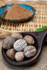 Tasty winter spice whole dried and ground powder nutmeg, used as an ingredient in many dishes, eggnog, potato, mulled wine