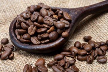 Fototapeta premium Arabica brown roasted coffee beans from Africa coffee producing region, cultivating in Ethiopia, Ivory Coast, Uganda, Kenya, Rwanda and Tanzania