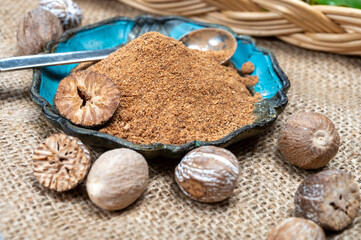 Tasty winter spice whole dried and ground powder nutmeg, used as an ingredient in many dishes, eggnog, potato, mulled wine