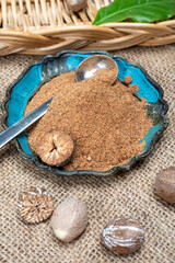 Tasty winter spice whole dried and ground powder nutmeg, used as an ingredient in many dishes, eggnog, potato, mulled wine