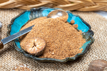 Tasty winter spice whole dried and ground powder nutmeg, used as an ingredient in many dishes, eggnog, potato, mulled wine