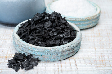 Black and white sea salt close up, Cyprus Black Salt shiny black pyramid-shaped crystals