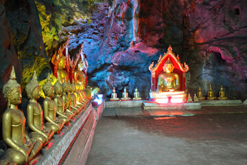 Row of Buddha statues at Tham Khao Luang Cave