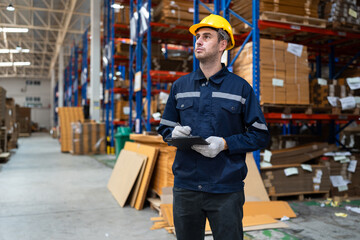 Portrait Caucasian businessman workers using tablet computer checking Kraft paper stock in warehouse	