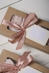 Box with homemade zephyr. Zephyr  flowers. Craft packaging tied with ribbon. Label with text field....