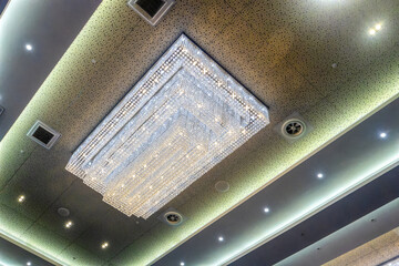 huge contemporary chandelier on the ceiling in a hall with a three dimensional design