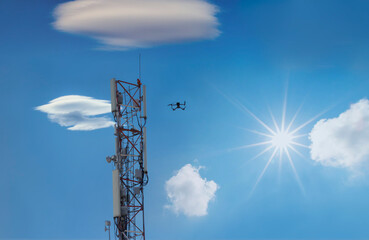 drone inspection cellphone tower, metal mast against the blue cloudy sky in a sunny day - Powered by Adobe