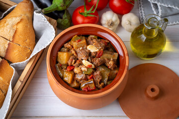 Top view of Turkish dish Guvech - baked meat with eggplant and traditionally served in earthenware pot (Turkish name; etli patlican guvec or patlican tava)