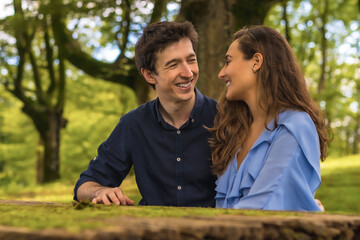 Couple looking at each other and smiling in a park