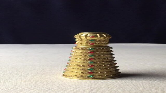A Detailed Look at a Gold-Decorated Attar Bottle