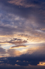 Evening sky. Yellow and violet clouds. Sunset in the clouds