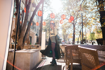 Full length portrait of Asian woman in front of Chinese lanterns. 