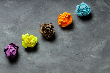 Crumpled Colorful Paper Balls on Gray Concrete, Concept of Uselessness and Worthlessness