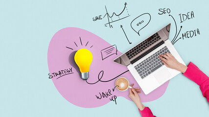 Creative workplace with strategy, laptop, yellow light bulb and plan, top view. Successful business girl works on a laptop and drinks coffee, concept. Management and workflow. Growth and start up - obrazy, fototapety, plakaty