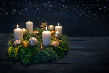 Green advent wreath with white candles, three are lit for third advent, Christmas decoration and cookies, dark blue wooden background with star bokeh, copy space - obrazy, fototapety, plakaty