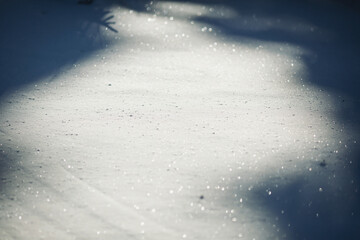 Snow cover, close-up, selective focus, shimmering with different colors in the sun. sparkling snow in the sun, natural winter background. Clean surface of the snow layer. Fresh untouched snow