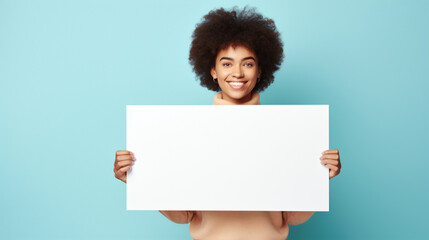 Happy curly african-american woman holding empty poster for advertising, smiling friendly female student with blank billboard isolated on plain blue background. AI generated